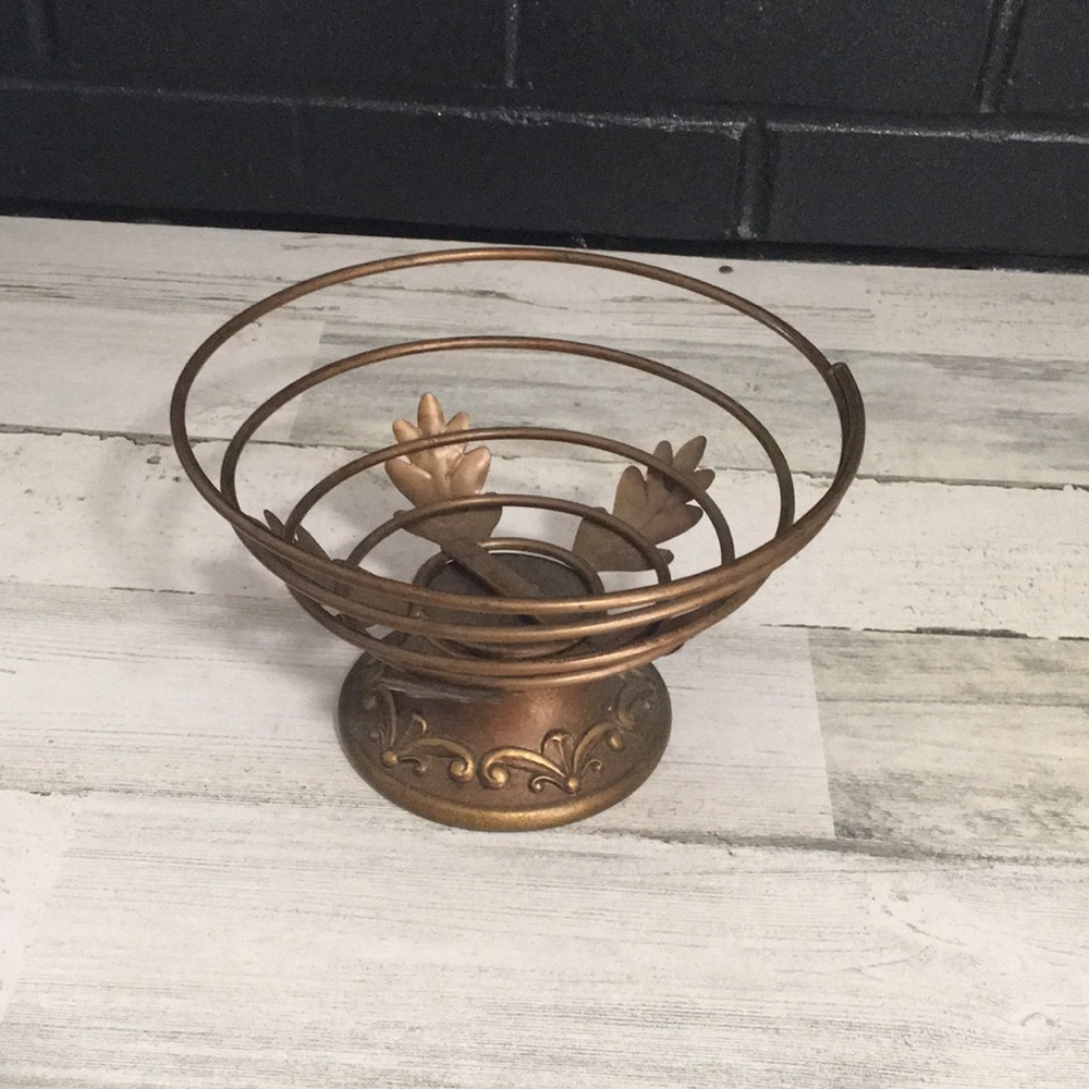 Gold tone flexible metal coiled wire basket with decorative base and leaves